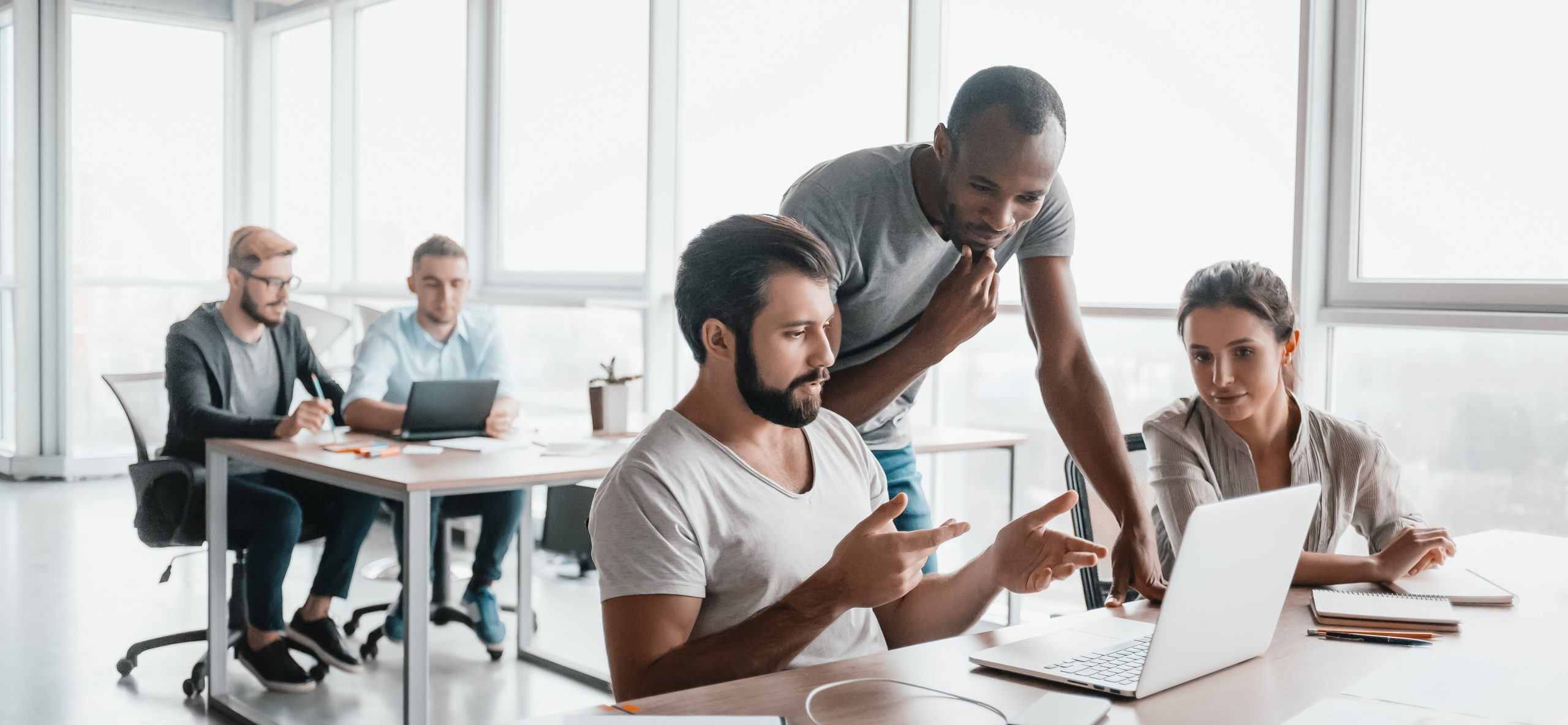 Website header of Three business colleagues discussing projects in modern office interior