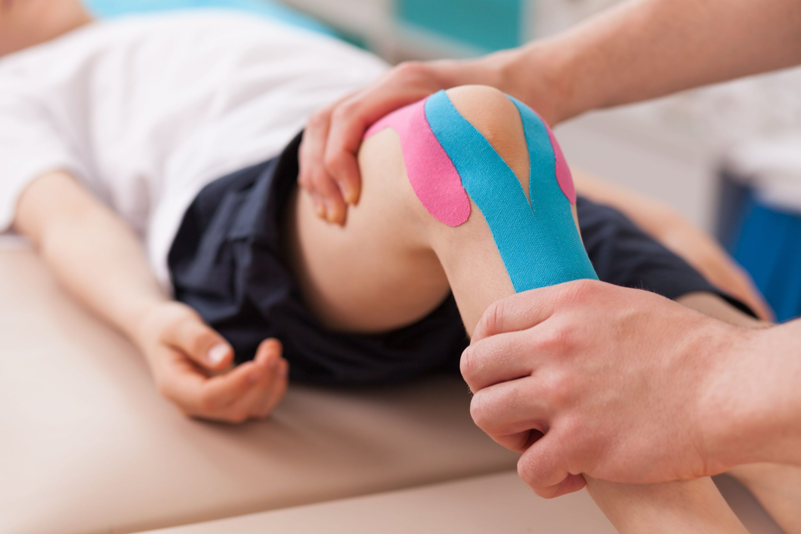 49175385 – physiotherapist doing with child exercise for knee